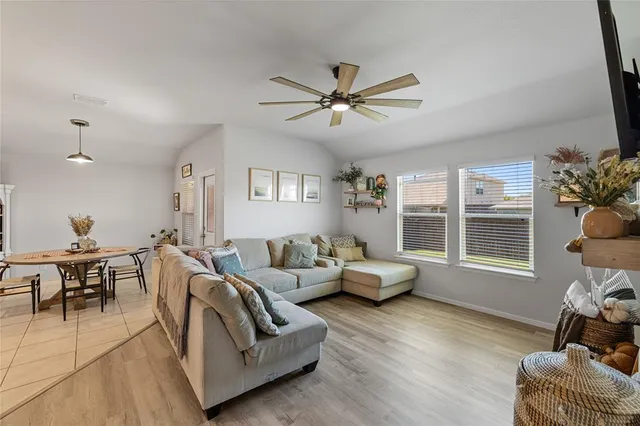 a view of a room with furniture and wooden floor