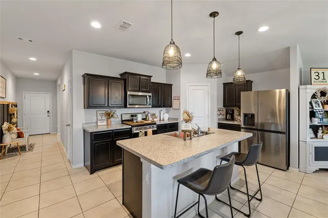 a kitchen with stainless steel appliances a sink stove and refrigerator