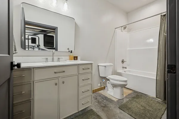 a view of a field with trees in the background