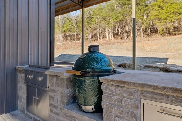 a view of a green field with mountains in the background