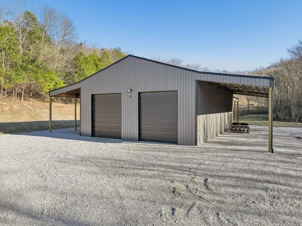 a view of a dry yard with wooden fence