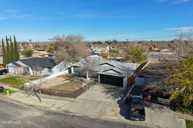 an aerial view of a house with a yard