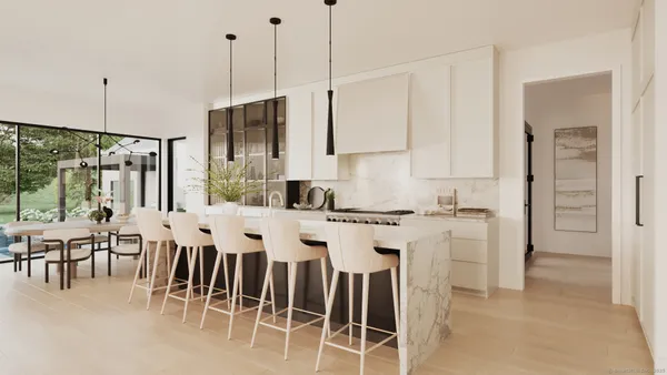 a kitchen with stainless steel appliances kitchen island granite countertop a dining table chairs and white cabinets