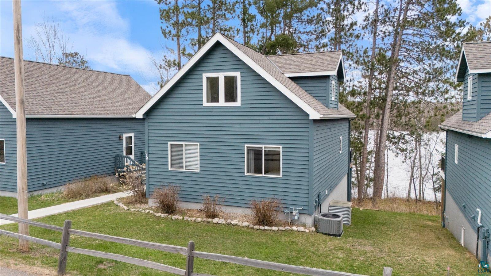 6266 Giants Ridge Road Biwabik, MN 55705 - Photo 1 of 37 Blue horizontal siding exterior with white trim and a gabled roof
