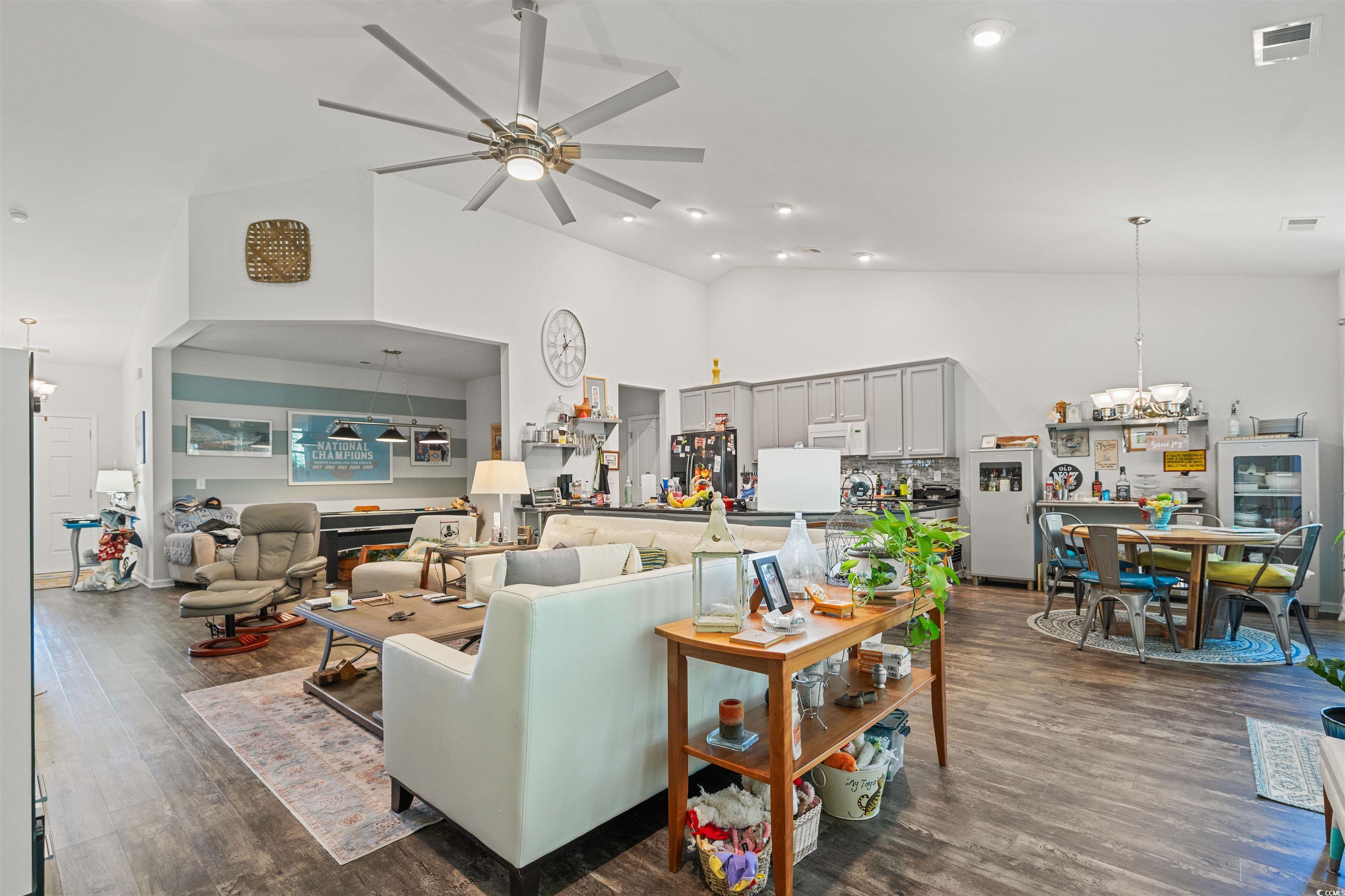 826 Cypress Way Little River, SC 29566 - Photo 11 of 40 Living area featuring dark wood finished floors, a chandelier, a ceiling fan, high vaulted ceiling, and recessed lighting