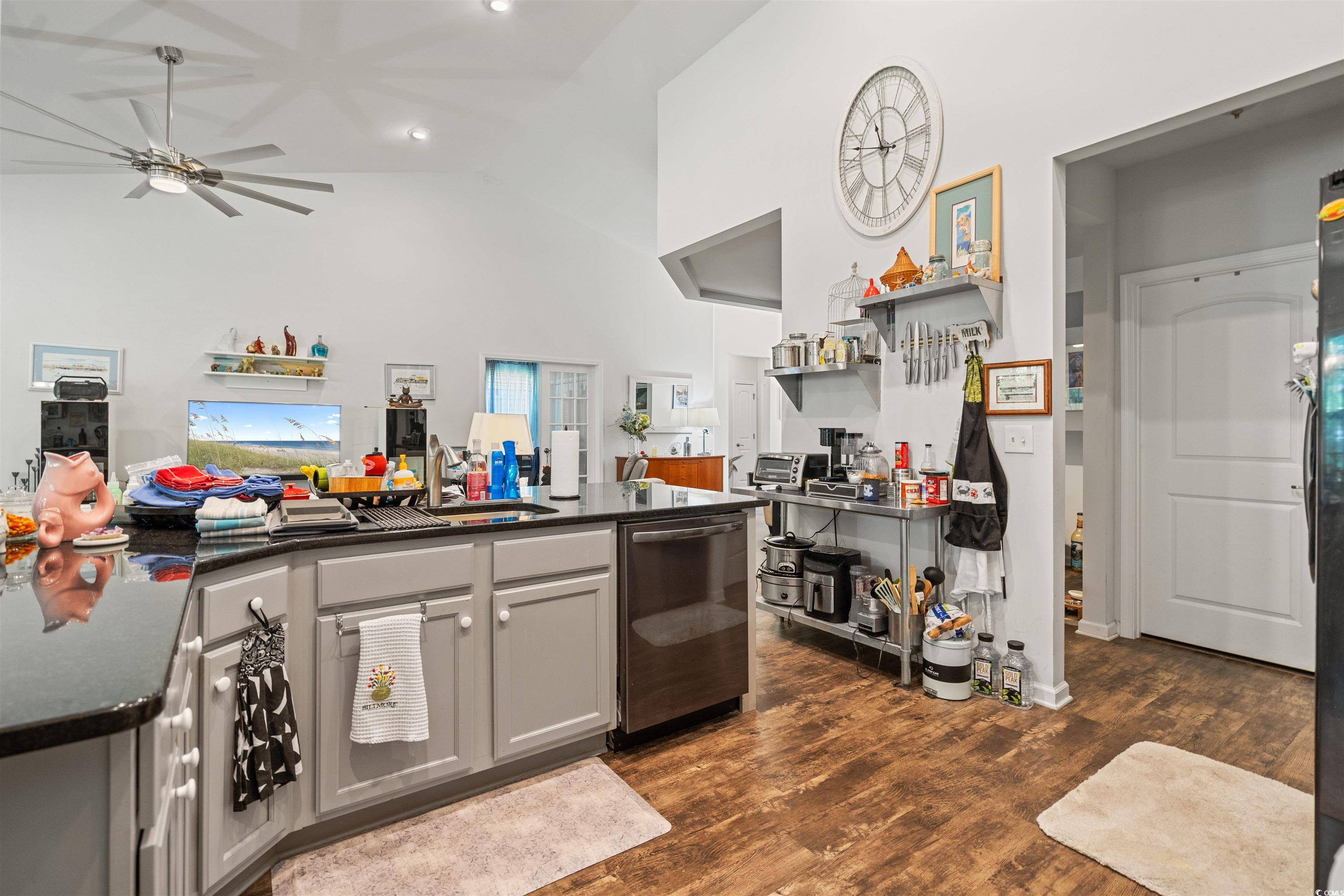 826 Cypress Way Little River, SC 29566 - Photo 39 of 40 Kitchen featuring dark wood finished floors, open floor plan, dishwasher, dark stone counters, and open shelves