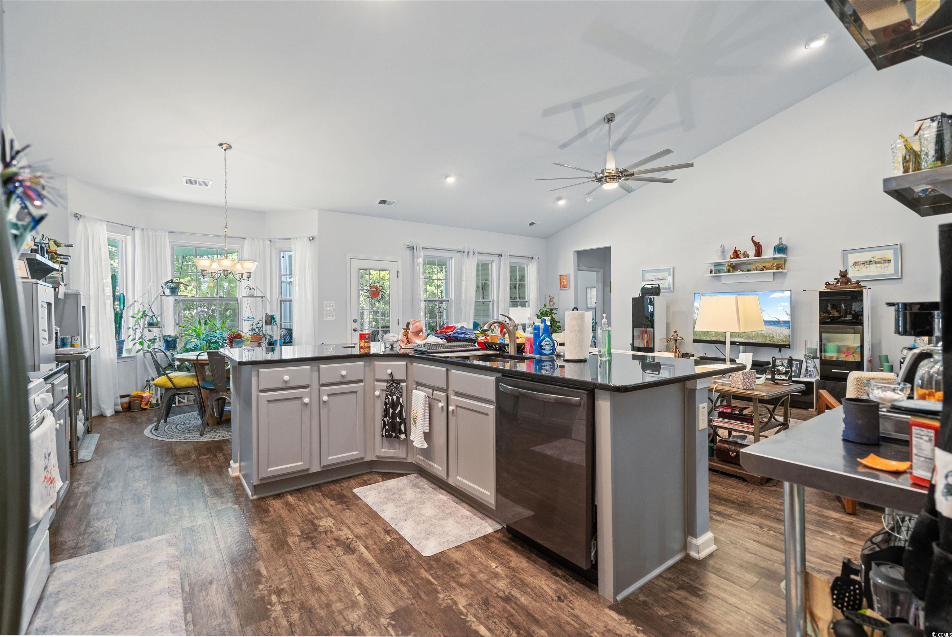 826 Cypress Way Little River, SC 29566 - Photo 40 of 40 Kitchen with vaulted ceiling, gray cabinetry, open floor plan, dark wood-style flooring, and stainless steel dishwasher
