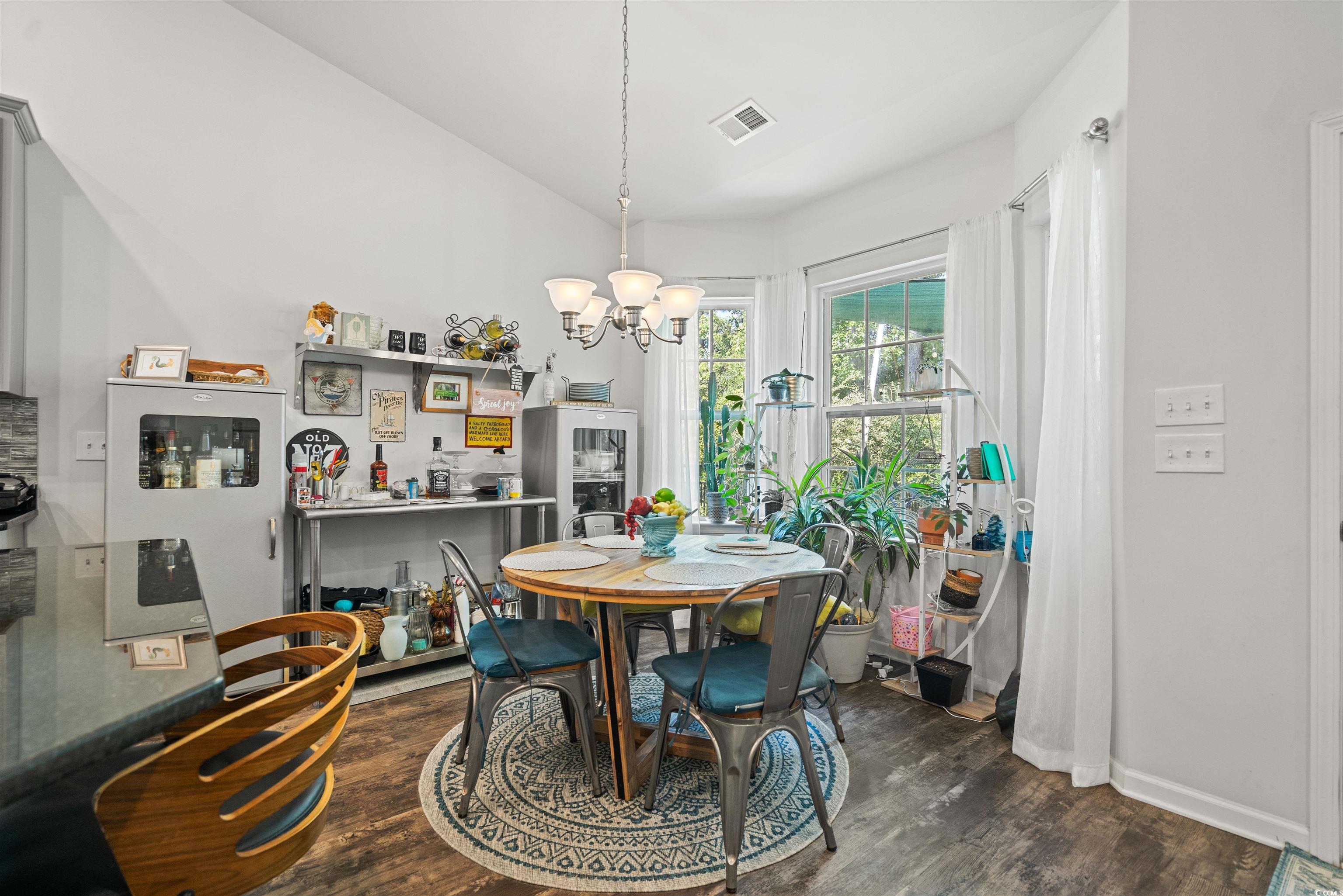 826 Cypress Way Little River, SC 29566 - Photo 18 of 40 Dining space featuring dark wood finished floors and a chandelier