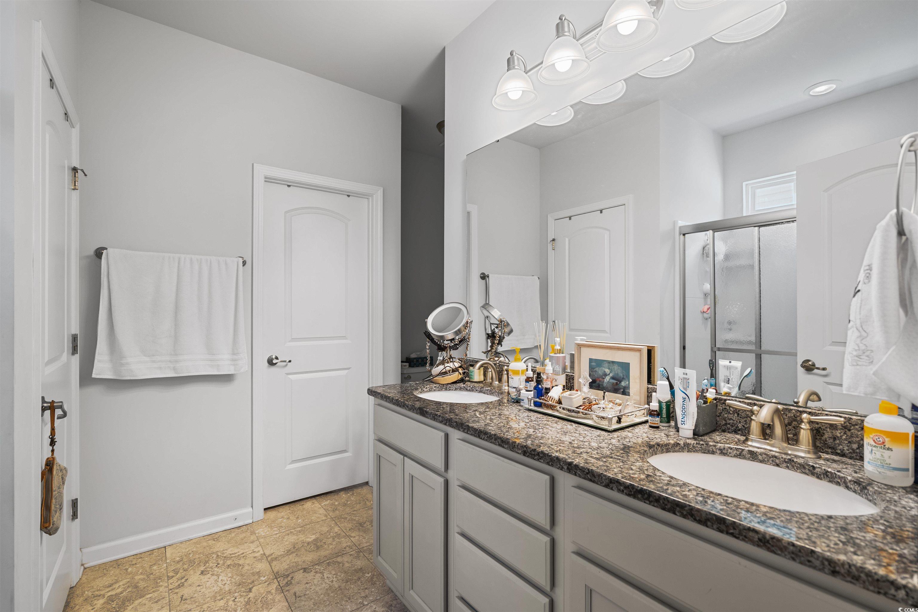826 Cypress Way Little River, SC 29566 - Photo 23 of 40 Bathroom featuring a shower stall and double vanity
