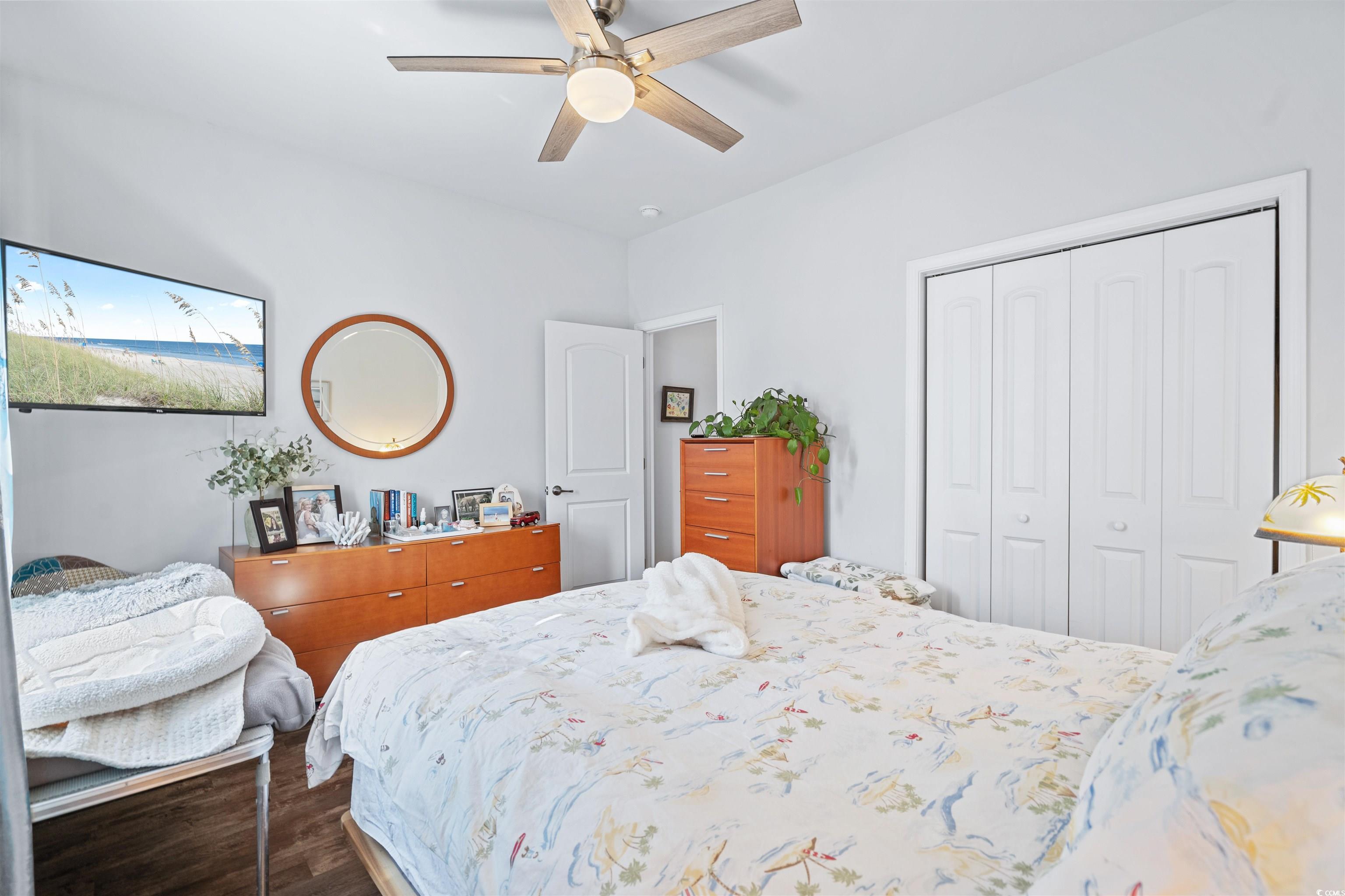 826 Cypress Way Little River, SC 29566 - Photo 26 of 40 Bedroom with a closet, dark wood-style flooring, and a ceiling fan