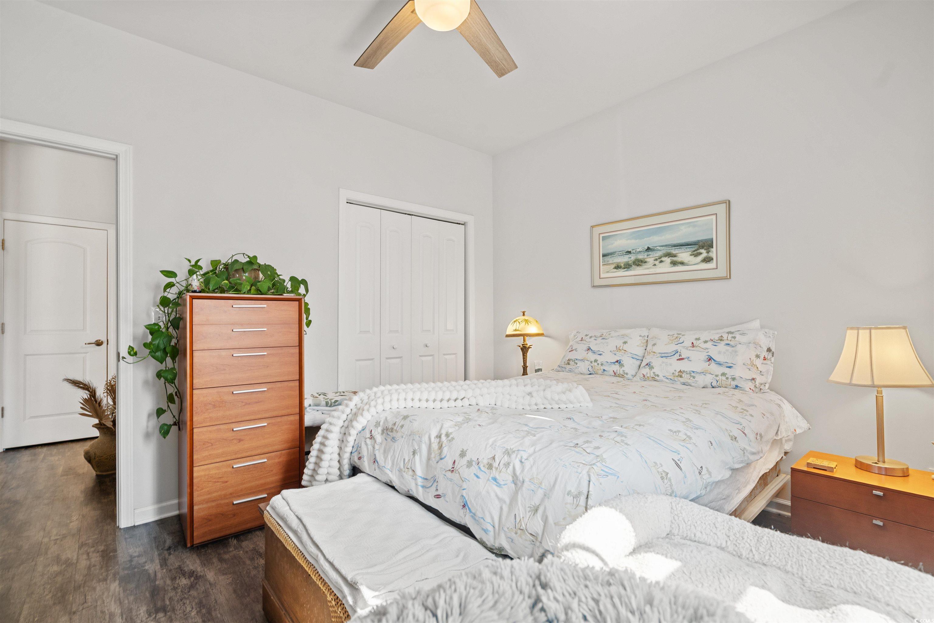 826 Cypress Way Little River, SC 29566 - Photo 27 of 40 Bedroom featuring a closet, dark wood-style flooring, and a ceiling fan