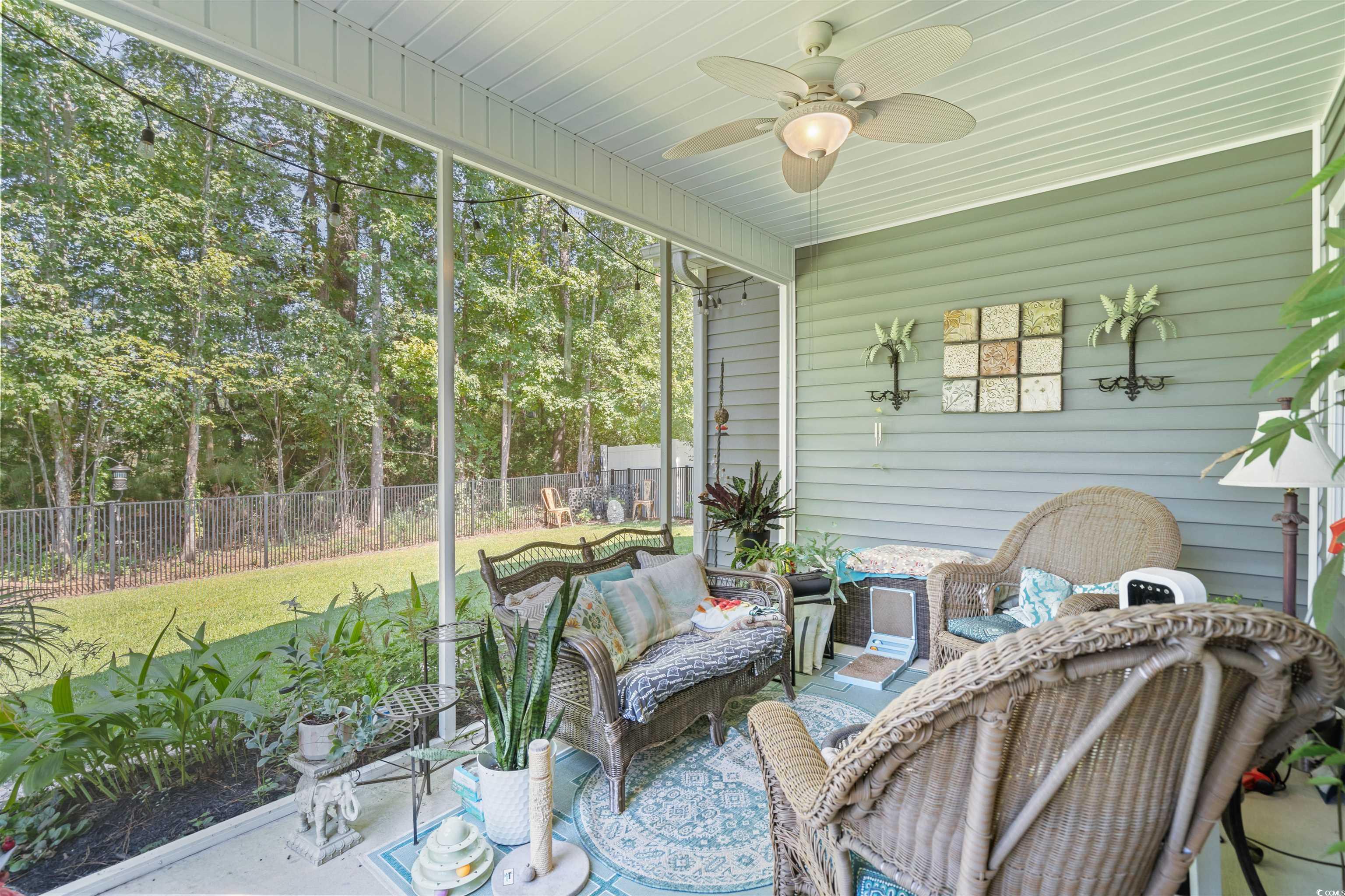 826 Cypress Way Little River, SC 29566 - Photo 28 of 40 Sunroom featuring a ceiling fan, an outdoor hangout area, a patio, and view of scattered trees