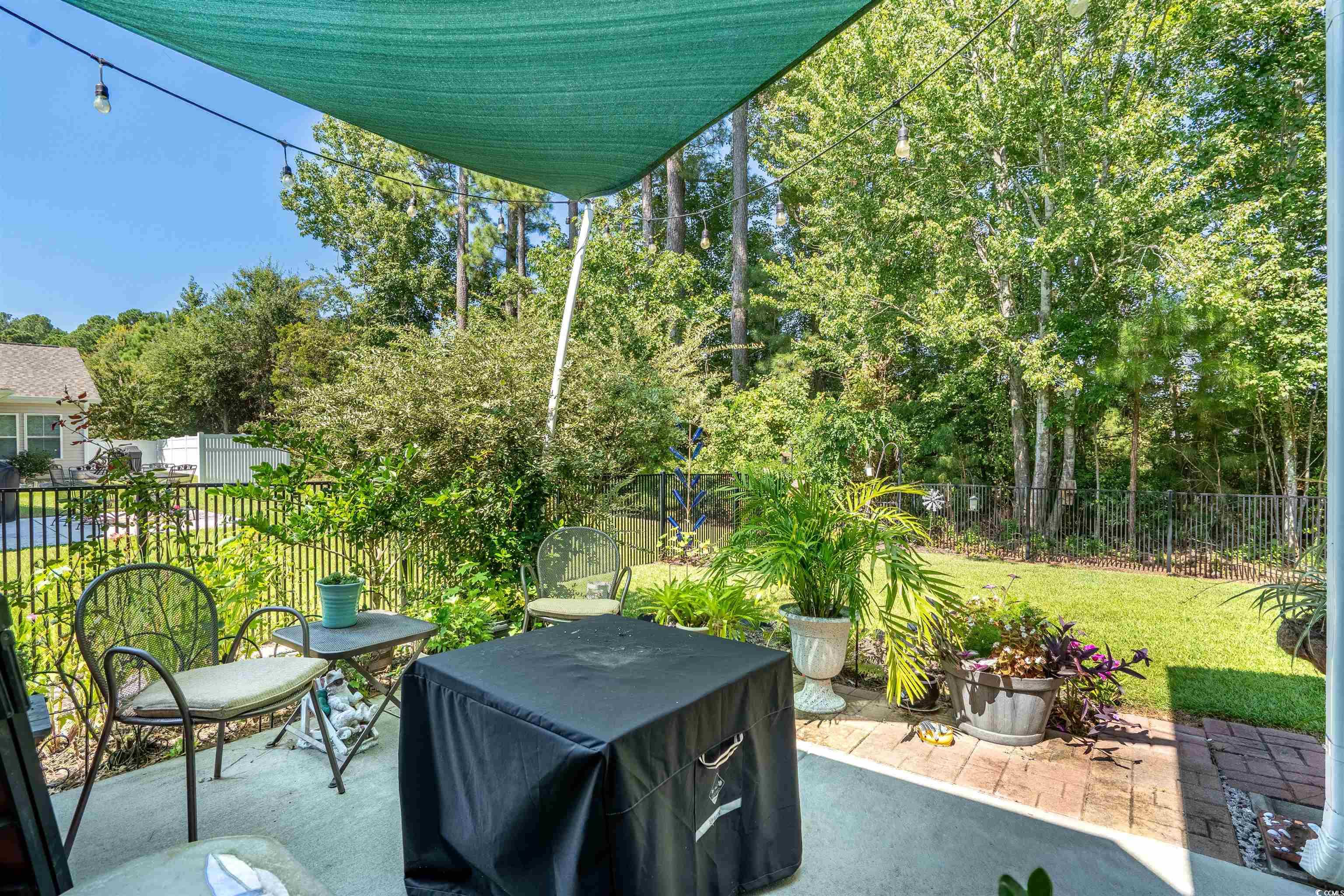 826 Cypress Way Little River, SC 29566 - Photo 30 of 40 Fenced backyard featuring a patio and view of wooded area