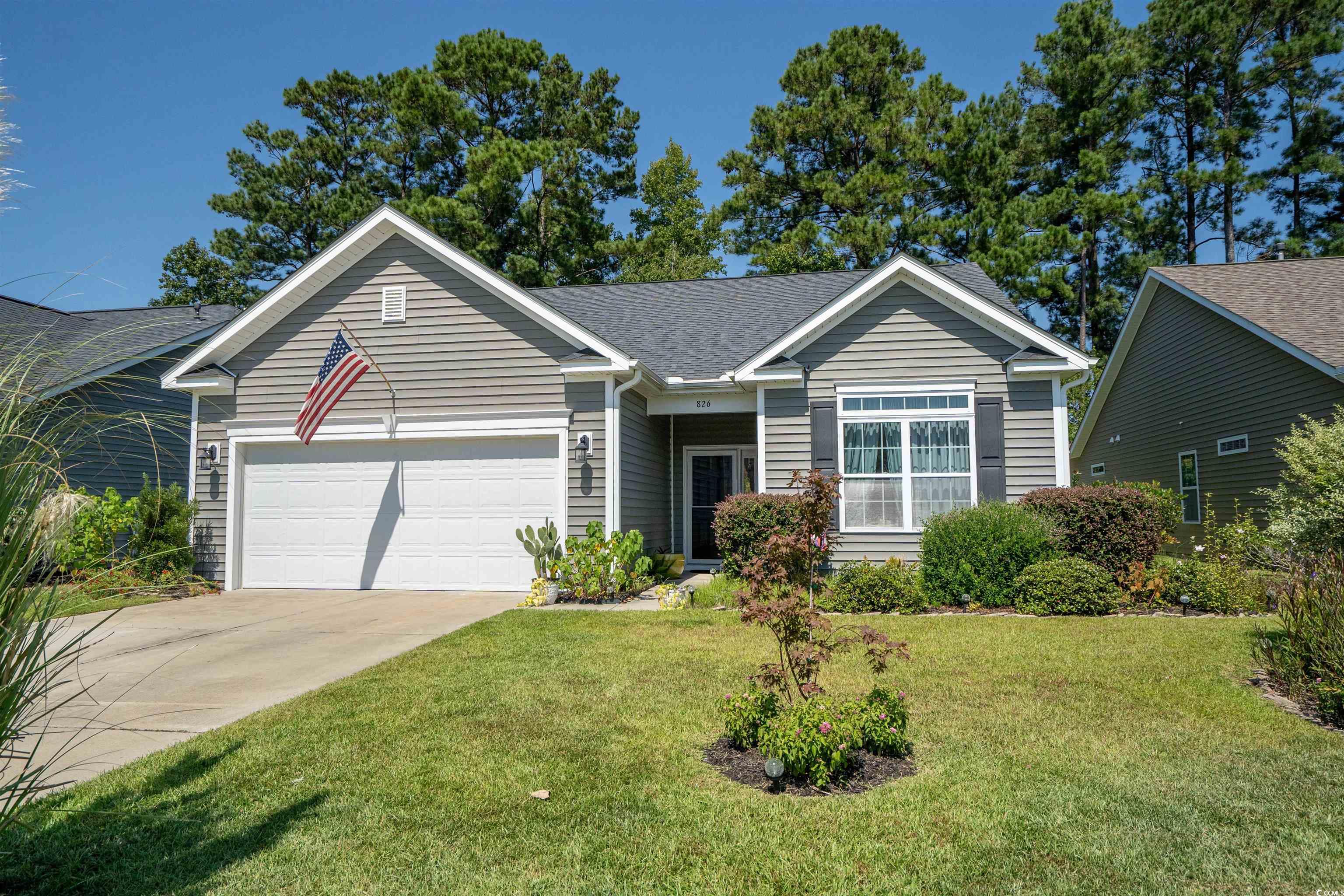 826 Cypress Way Little River, SC 29566 - Photo 4 of 40 Ranch-style house featuring a front yard, concrete driveway, a garage, and roof with shingles