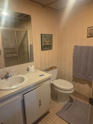 a bathroom with a toilet sink and mirror