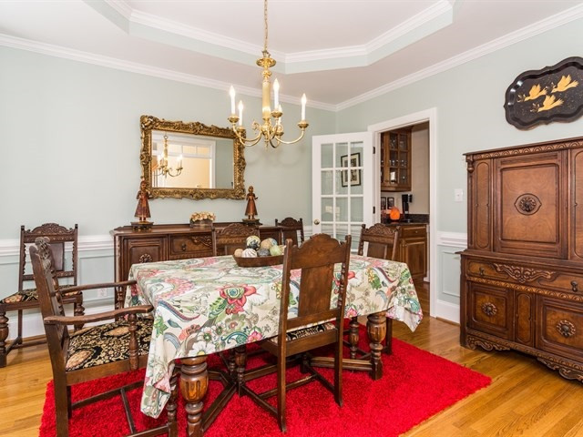 8004 Millenium Drive Raleigh, NC 27614 - Photo 6 of 24 Attractive moldings, tray ceiling and chandelier in the formal dining room. Dining Room
