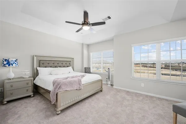 a bedroom with a large bed and a window