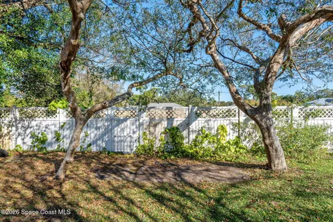 a backyard of a house with large trees