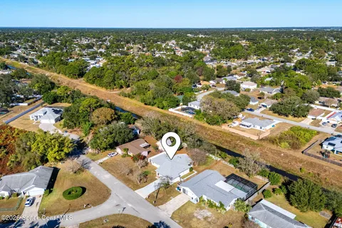 an aerial view of a house with outdoor space