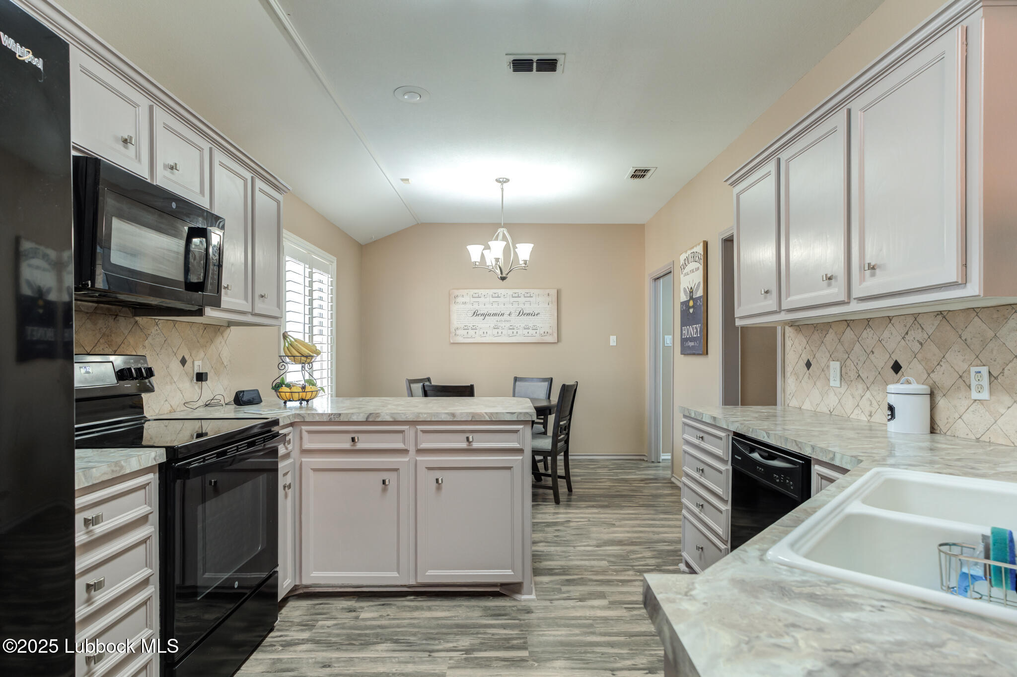 144 North Utica Avenue Lubbock, TX 79416 - Photo 13 of 46 a kitchen with stainless steel appliances kitchen island granite countertop a sink stove and cabinets