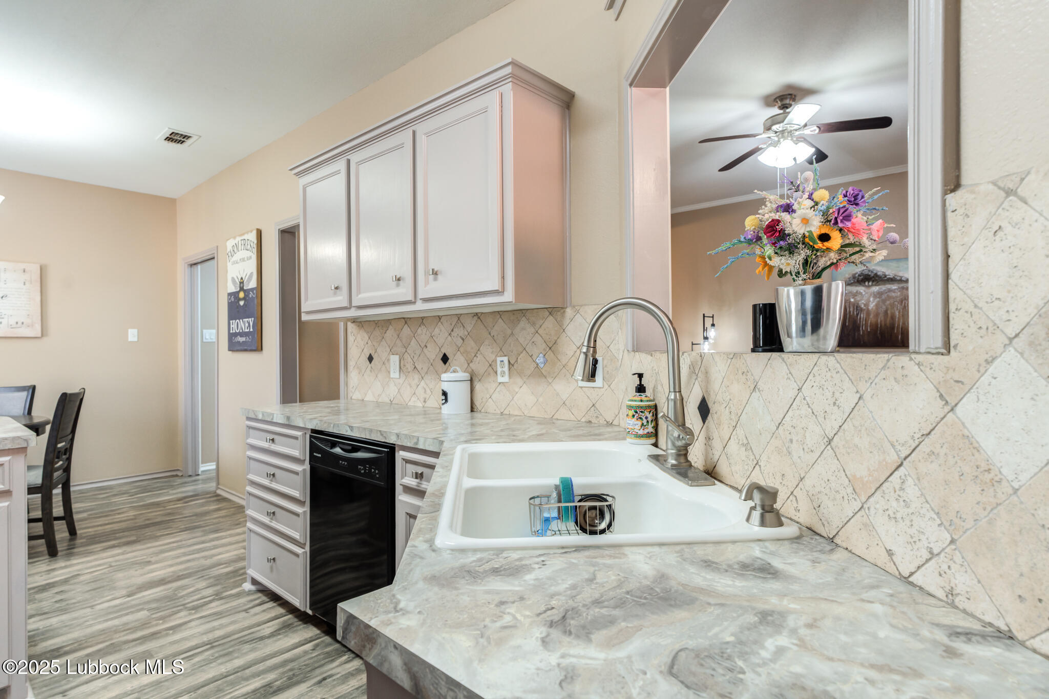 144 North Utica Avenue Lubbock, TX 79416 - Photo 14 of 46 a kitchen with stainless steel appliances granite countertop a sink stove and cabinets