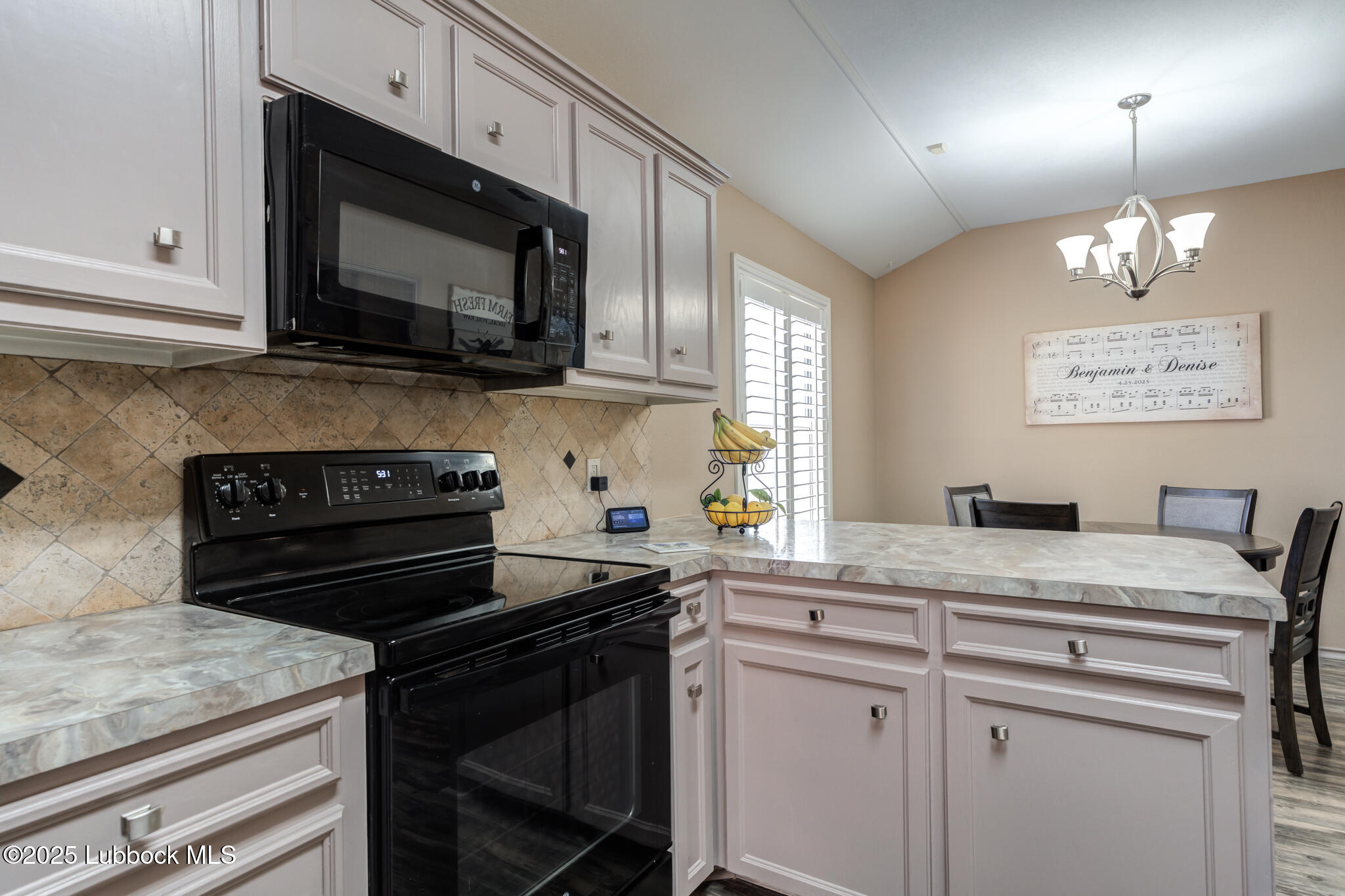 144 North Utica Avenue Lubbock, TX 79416 - Photo 15 of 46 a kitchen with a stove and a microwave