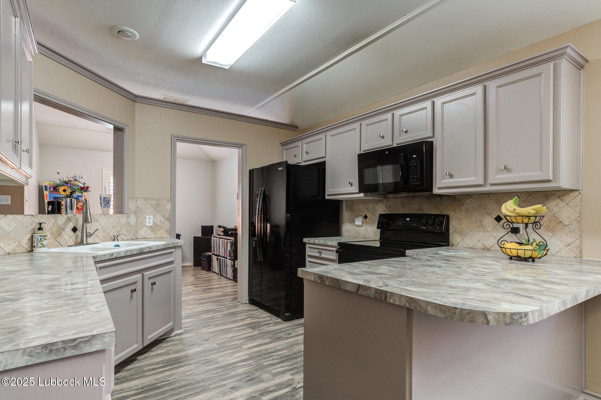 144 North Utica Avenue Lubbock, TX 79416 - Photo 17 of 46 a kitchen with a sink stove and refrigerator