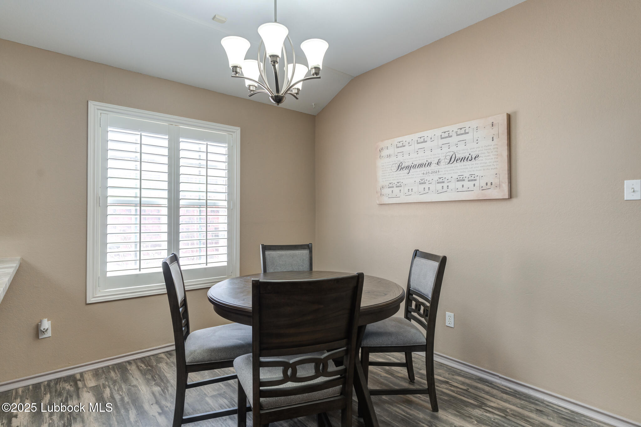 144 North Utica Avenue Lubbock, TX 79416 - Photo 19 of 46 a view of a dining room with furniture a chandelier and wooden floor