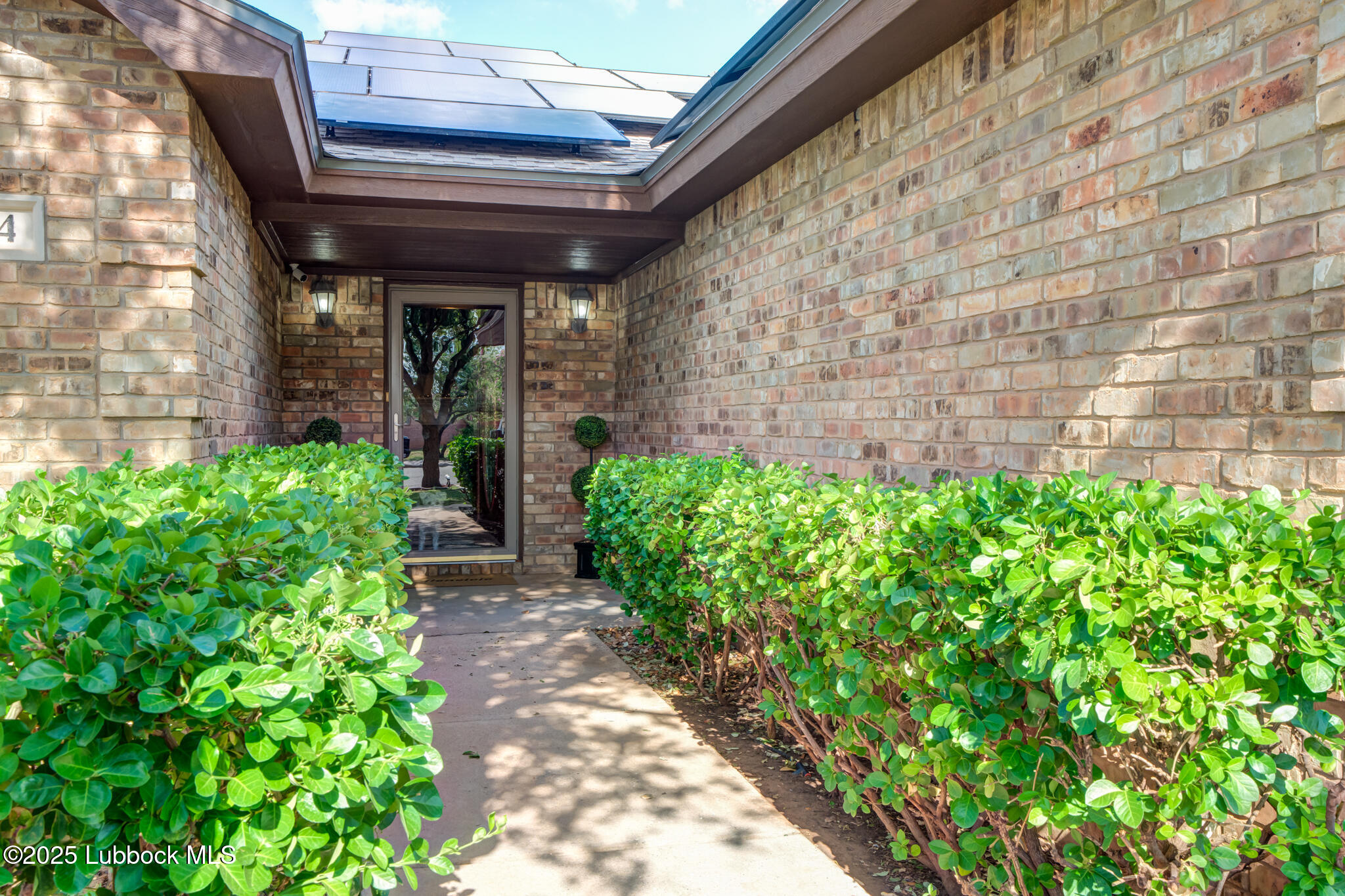 144 North Utica Avenue Lubbock, TX 79416 - Photo 2 of 46 a view of yellow house with potted plants