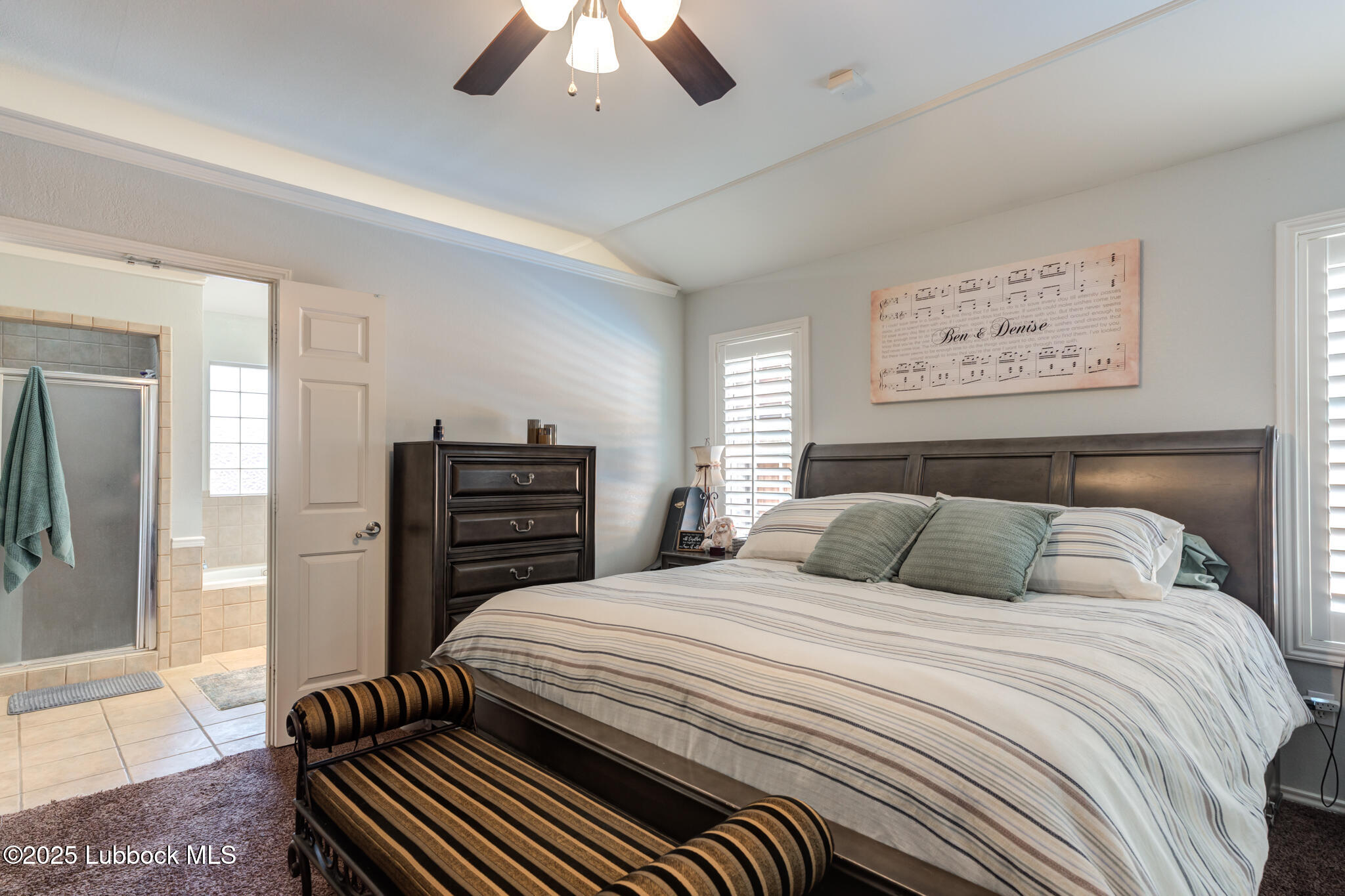144 North Utica Avenue Lubbock, TX 79416 - Photo 22 of 46 a bedroom with a bed and a chandelier