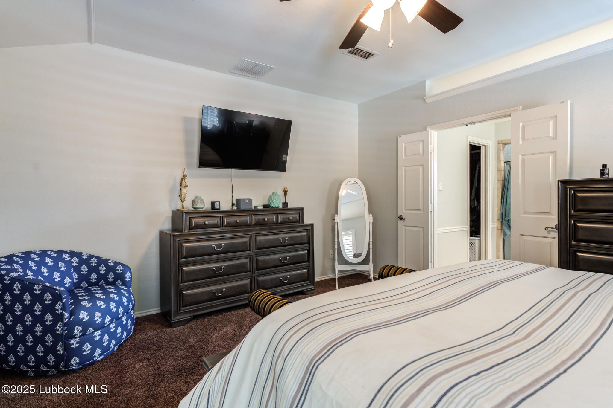 144 North Utica Avenue Lubbock, TX 79416 - Photo 24 of 46 a bedroom with a bed and a flat screen tv
