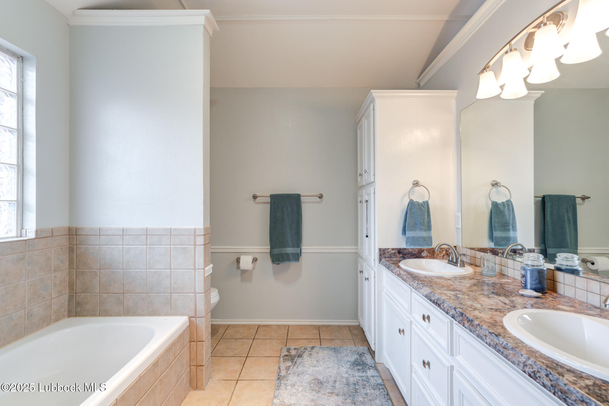 144 North Utica Avenue Lubbock, TX 79416 - Photo 25 of 46 a bathroom with a granite countertop tub sink and mirror