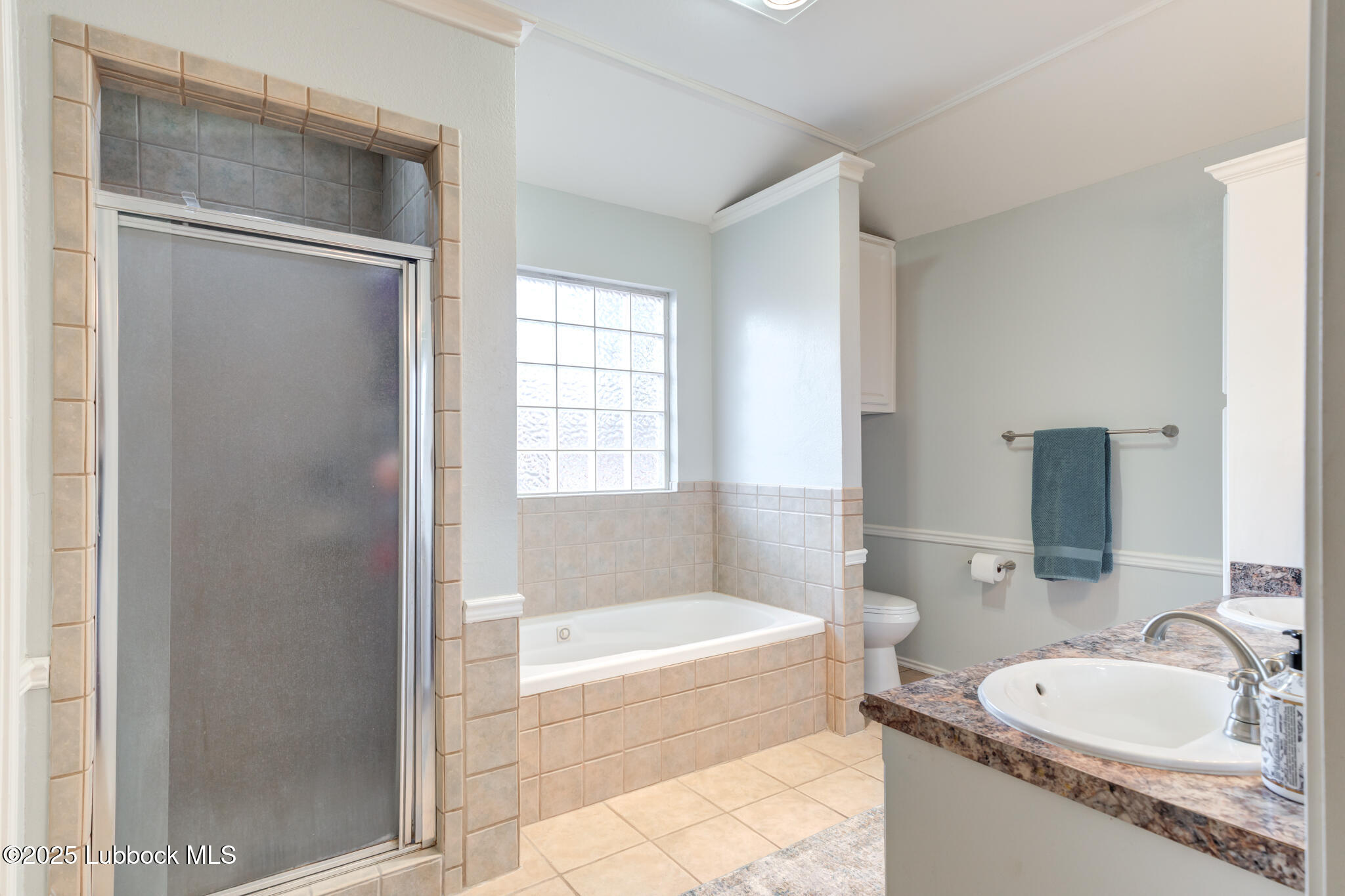 144 North Utica Avenue Lubbock, TX 79416 - Photo 26 of 46 a bathroom with a tub sink and mirror