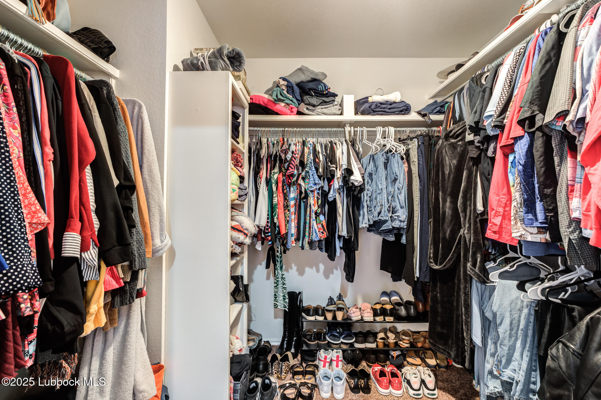 144 North Utica Avenue Lubbock, TX 79416 - Photo 27 of 46 a view of walk in closet with clothes