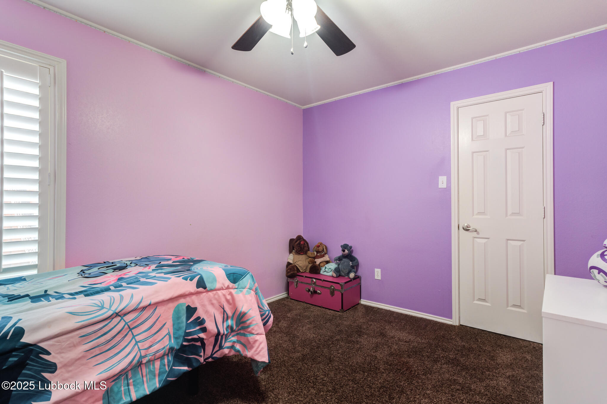 144 North Utica Avenue Lubbock, TX 79416 - Photo 30 of 46 a bedroom with pink walls and bed
