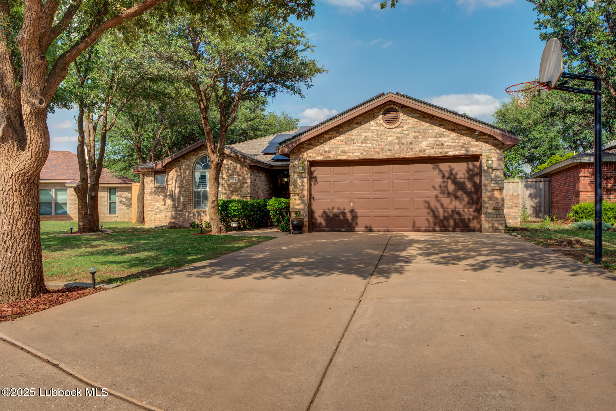 144 North Utica Avenue Lubbock, TX 79416 - Photo 3 of 46 a view of a house with a yard and palm trees