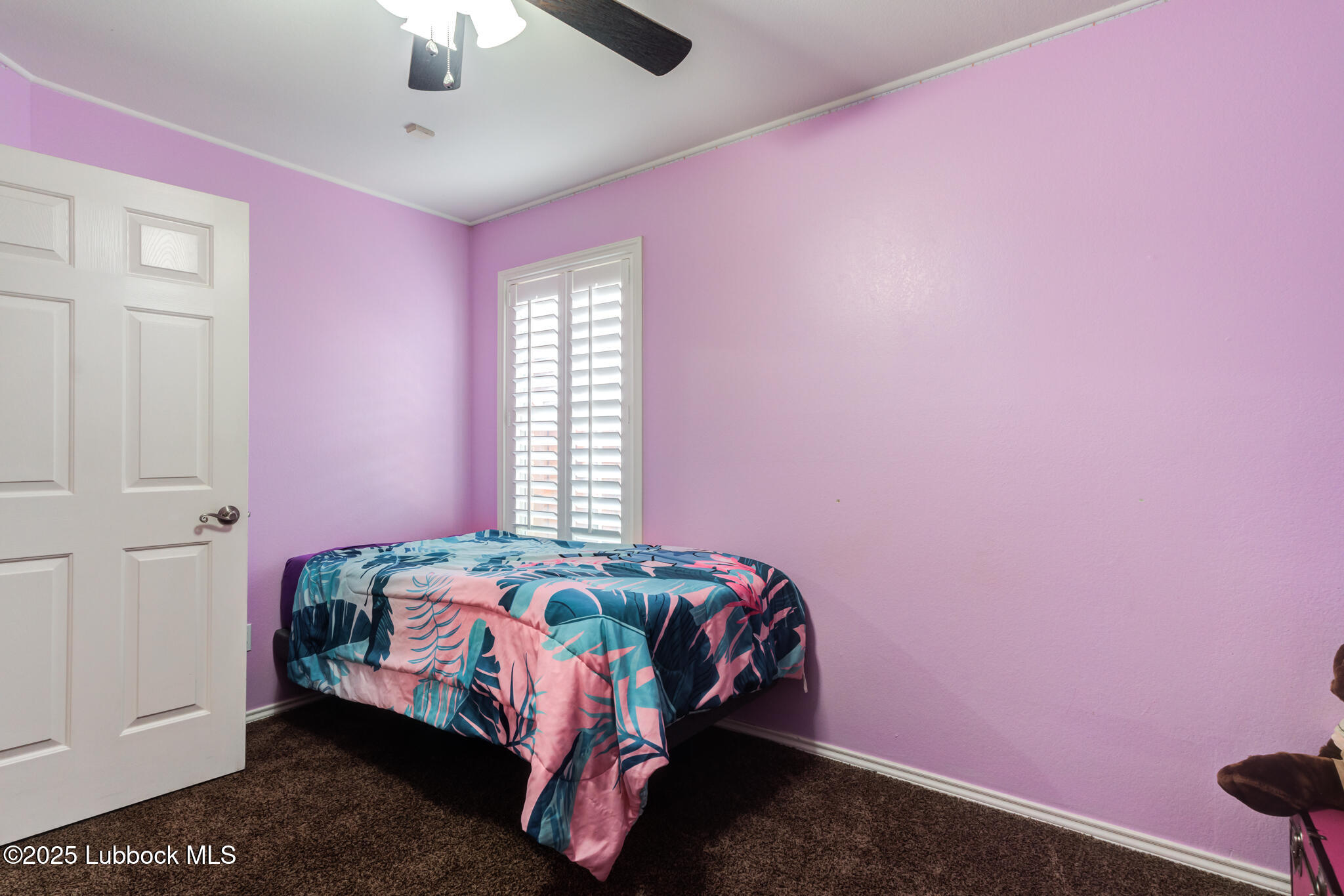 144 North Utica Avenue Lubbock, TX 79416 - Photo 31 of 46 a bedroom with a bed and a chandelier