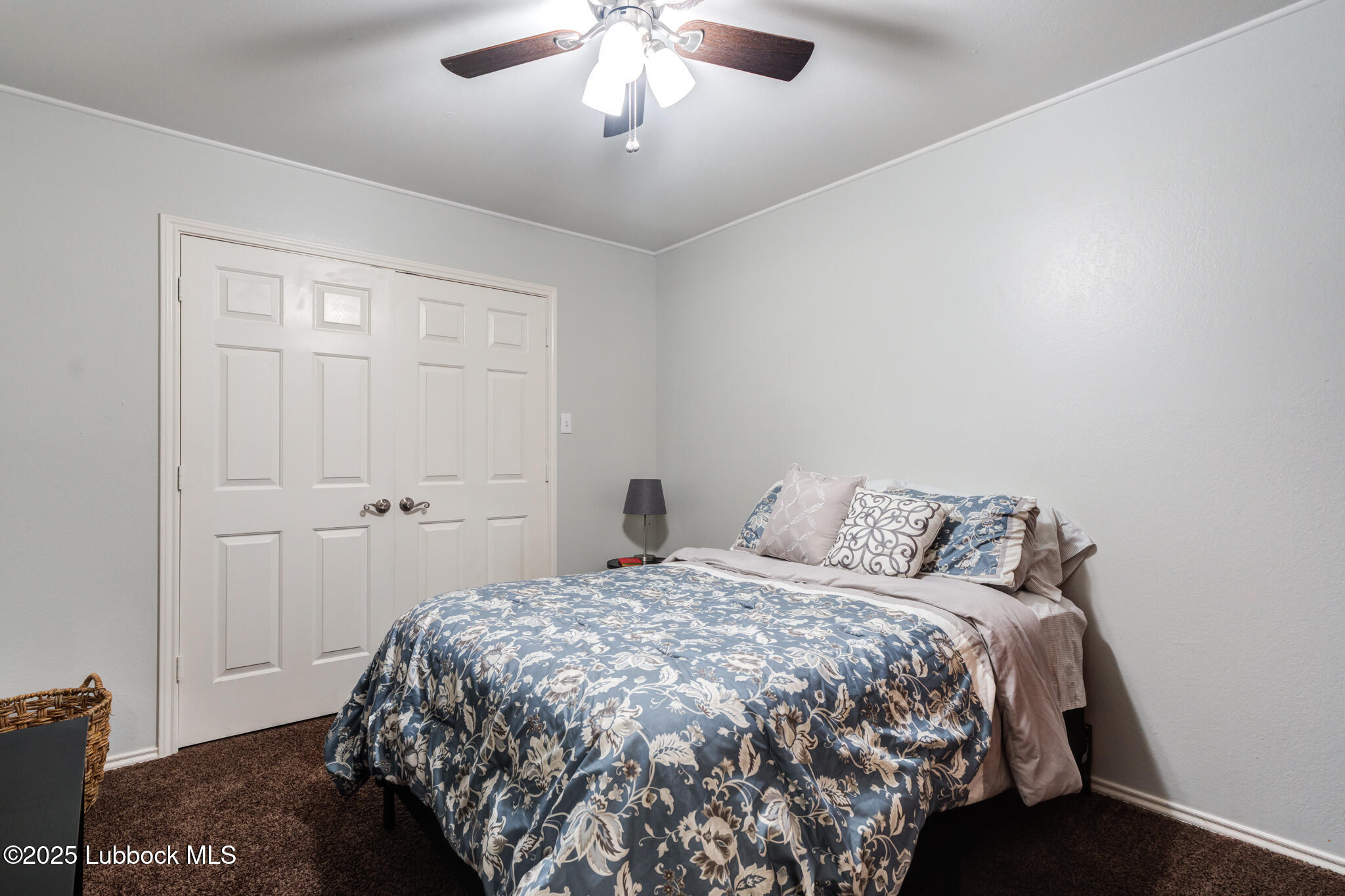144 North Utica Avenue Lubbock, TX 79416 - Photo 33 of 46 a bedroom with a bed and a chandelier