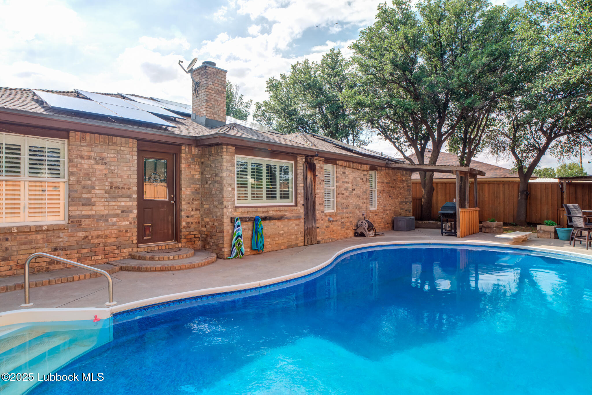 144 North Utica Avenue Lubbock, TX 79416 - Photo 40 of 46 a view of a house with swimming pool and sitting area