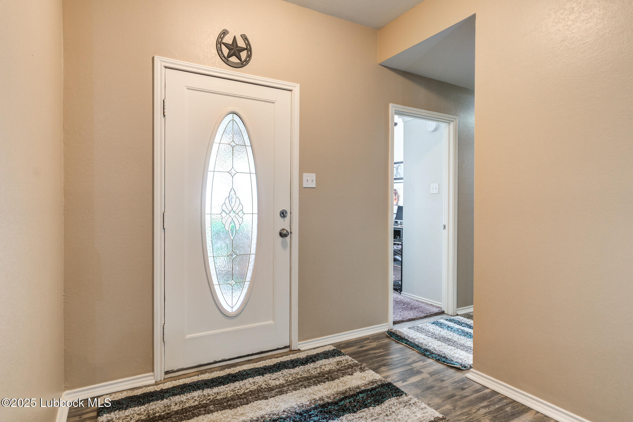144 North Utica Avenue Lubbock, TX 79416 - Photo 4 of 46 a view of an entryway with wooden floor