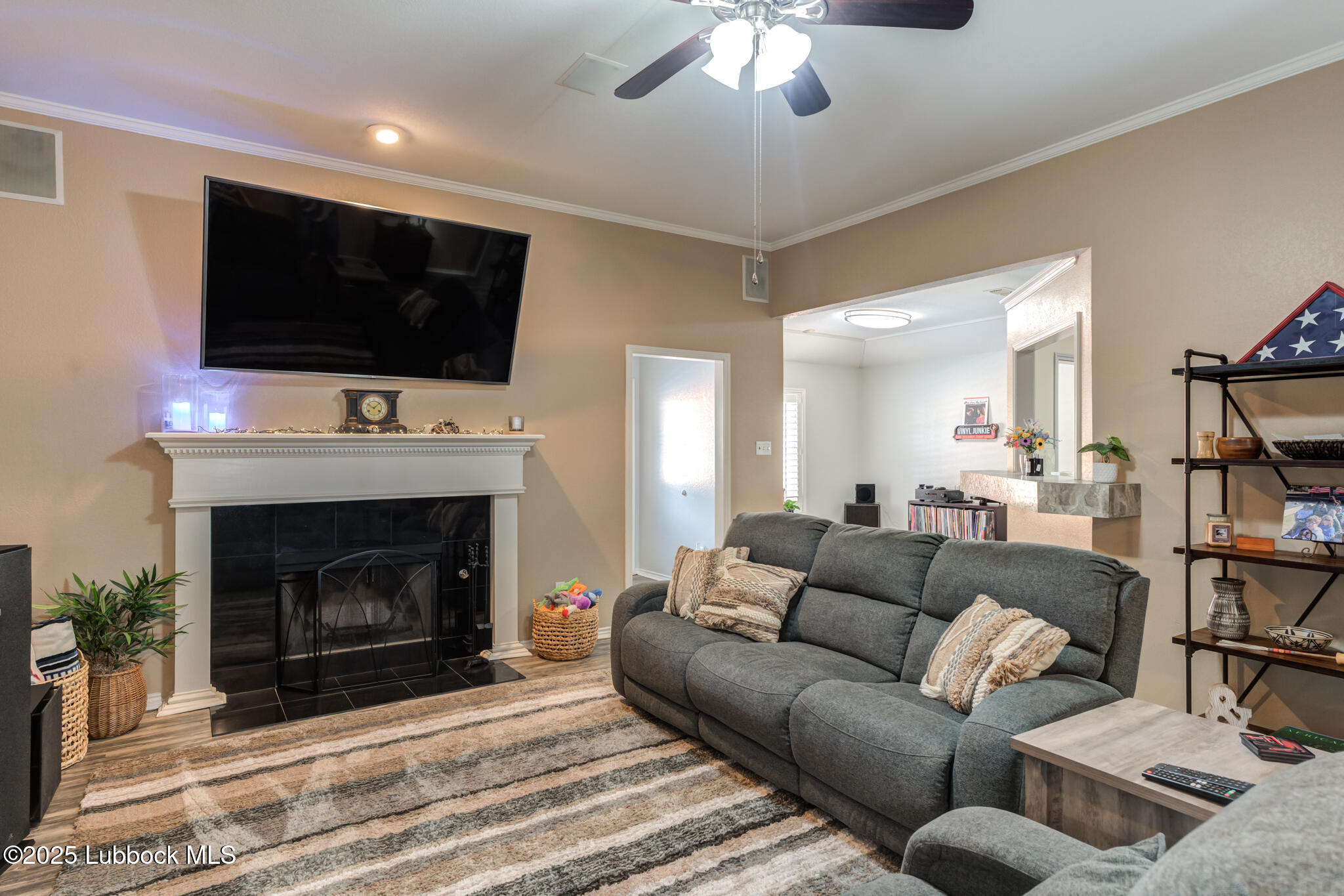 144 North Utica Avenue Lubbock, TX 79416 - Photo 9 of 46 a living room with furniture a flat screen tv and a fireplace
