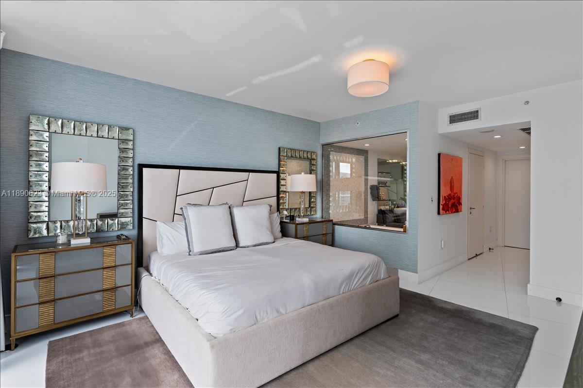 200 Biscayne Blvd Way, Unit 3608 Miami, FL 33131 - Photo 13 of 31 a bedroom with a large bed and a chandelier