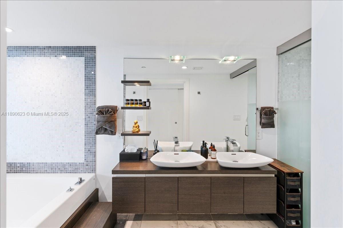 200 Biscayne Blvd Way, Unit 3608 Miami, FL 33131 - Photo 14 of 31 a bathroom with a sink mirror and a bathtub