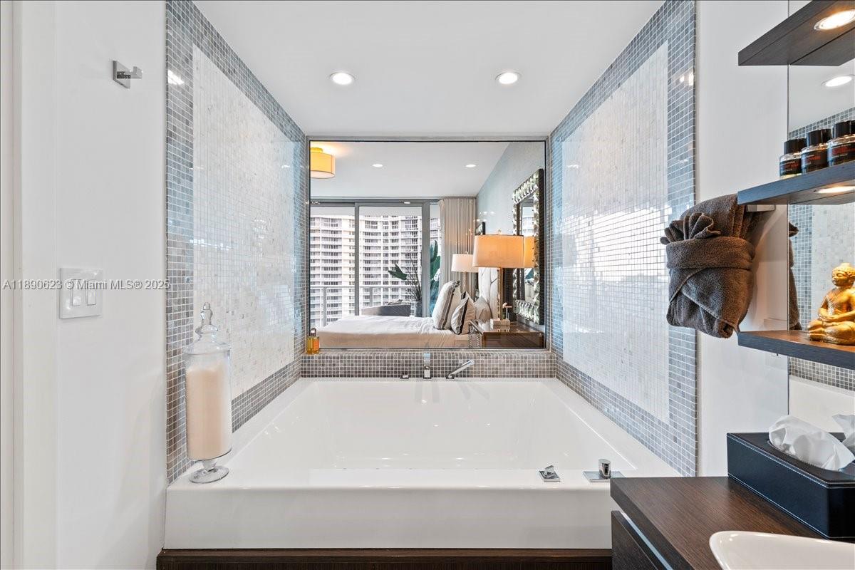 200 Biscayne Blvd Way, Unit 3608 Miami, FL 33131 - Photo 16 of 31 a bathroom with a bathtub and a window