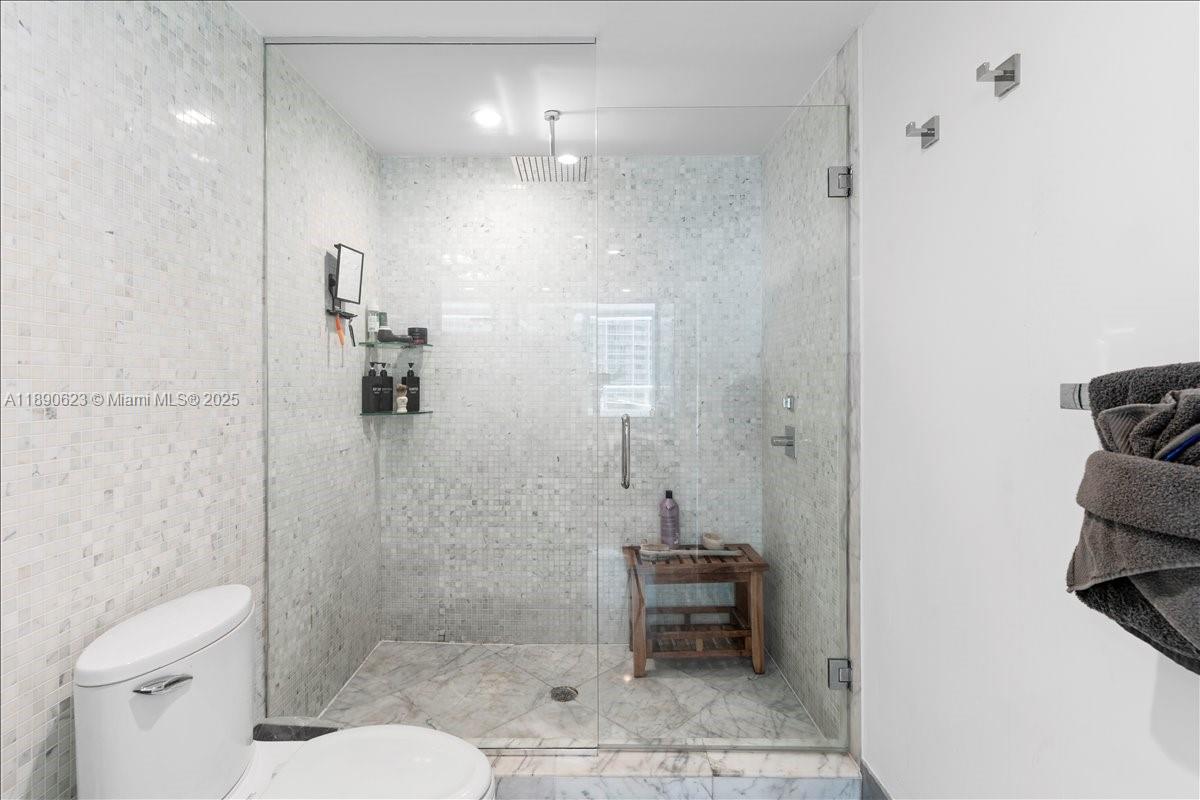 200 Biscayne Blvd Way, Unit 3608 Miami, FL 33131 - Photo 18 of 31 a bathroom with a toilet a sink and shower