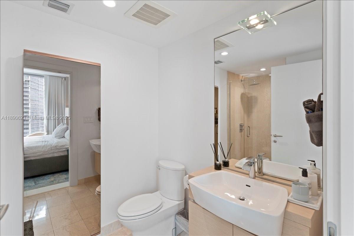 200 Biscayne Blvd Way, Unit 3608 Miami, FL 33131 - Photo 21 of 31 a bathroom with a sink a toilet and shower