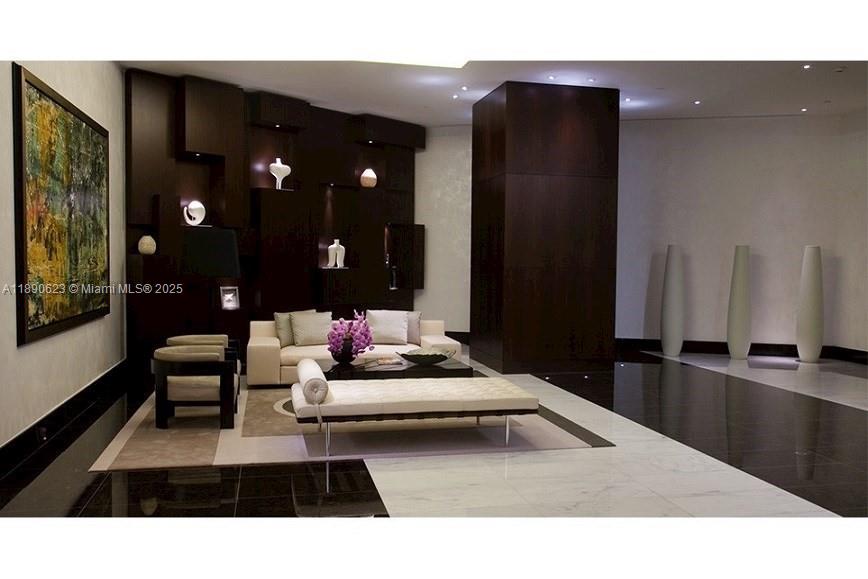 200 Biscayne Blvd Way, Unit 3608 Miami, FL 33131 - Photo 26 of 31 a living room with furniture and a lamp