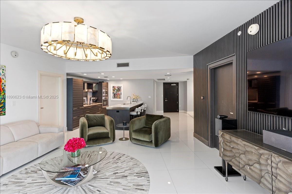 200 Biscayne Blvd Way, Unit 3608 Miami, FL 33131 - Photo 4 of 31 a living room with furniture chandelier and a flat screen tv