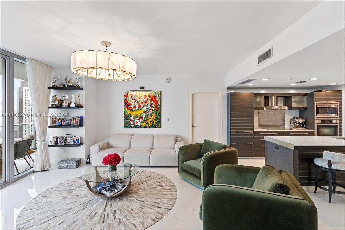 200 Biscayne Blvd Way, Unit 3608 Miami, FL 33131 - Photo 6 of 31 a living room with furniture a dining table and a chandelier