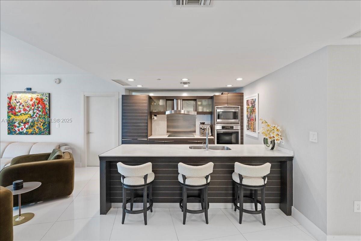 200 Biscayne Blvd Way, Unit 3608 Miami, FL 33131 - Photo 8 of 31 a kitchen with a table and chairs in it